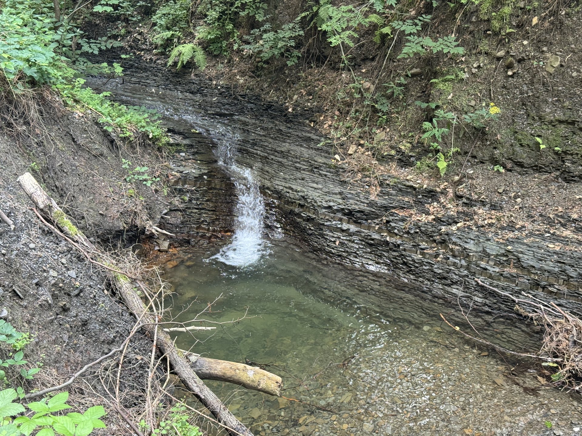 Layered rock formations and stair-step waterfalls